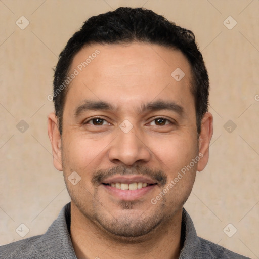 Joyful white young-adult male with short  black hair and brown eyes