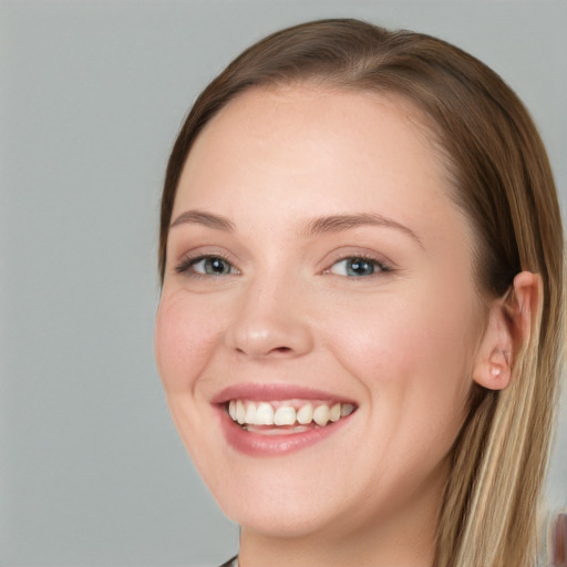 Joyful white young-adult female with long  brown hair and blue eyes