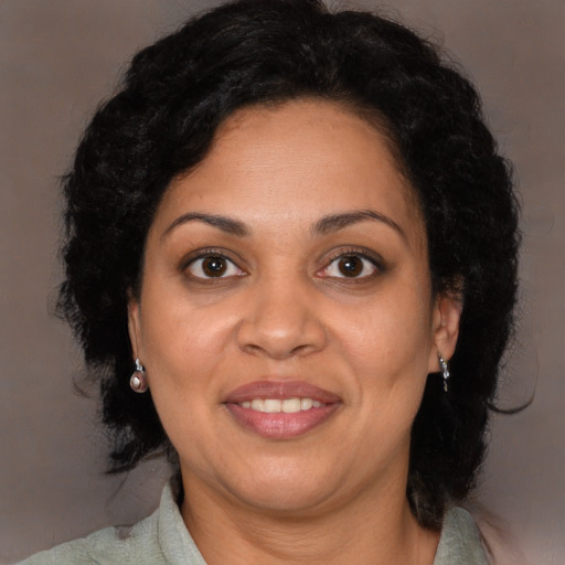 Joyful black adult female with medium  brown hair and brown eyes