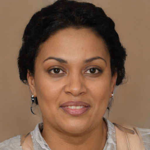 Joyful latino adult female with short  brown hair and brown eyes