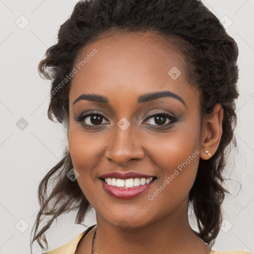 Joyful black young-adult female with long  brown hair and brown eyes