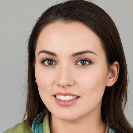 Joyful white young-adult female with long  brown hair and brown eyes