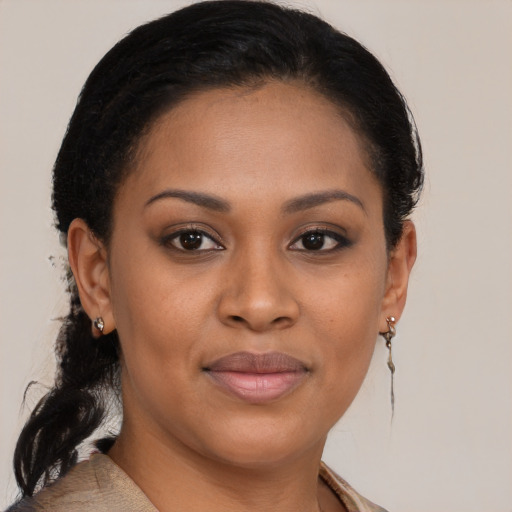 Joyful black young-adult female with medium  brown hair and brown eyes