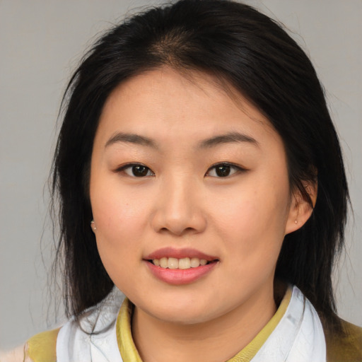 Joyful asian young-adult female with medium  brown hair and brown eyes