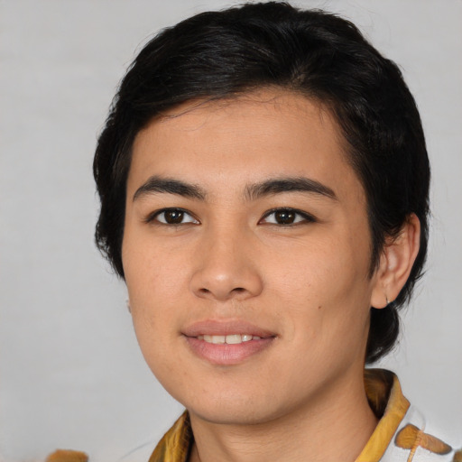 Joyful asian young-adult male with medium  black hair and brown eyes