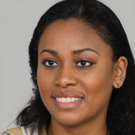 Joyful latino young-adult female with long  black hair and brown eyes
