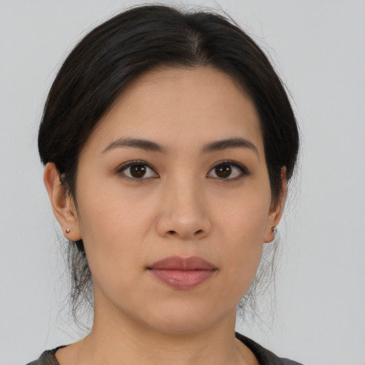 Joyful asian young-adult female with medium  black hair and brown eyes