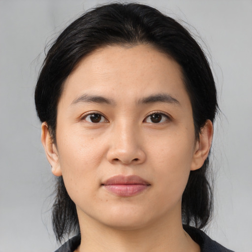 Joyful asian young-adult female with medium  black hair and brown eyes