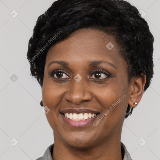 Joyful black young-adult female with short  black hair and brown eyes