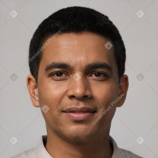 Joyful latino young-adult male with short  black hair and brown eyes