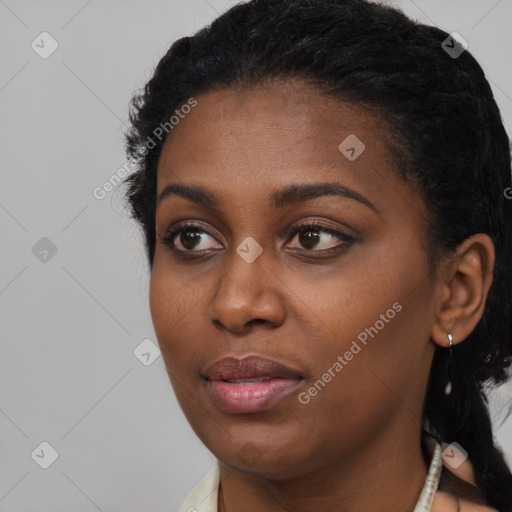 Joyful black young-adult female with short  black hair and brown eyes