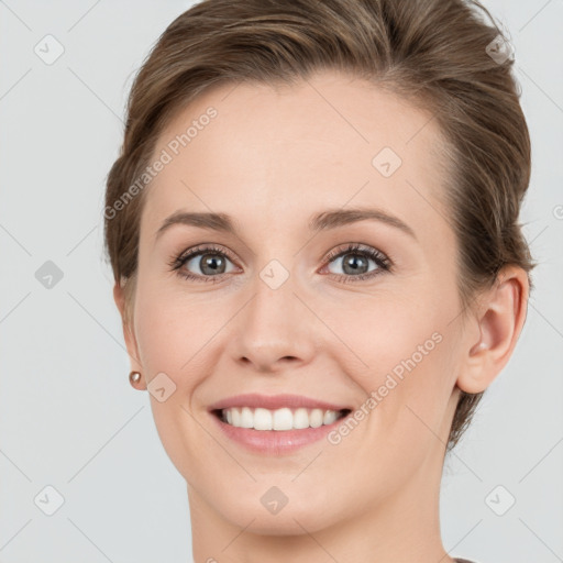 Joyful white young-adult female with medium  brown hair and grey eyes