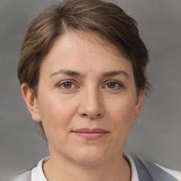 Joyful white adult female with short  brown hair and brown eyes