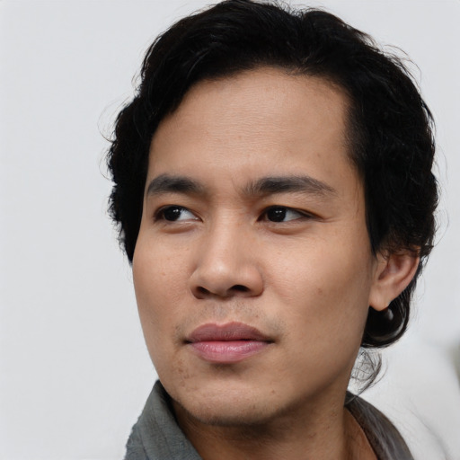 Joyful asian young-adult male with medium  black hair and brown eyes