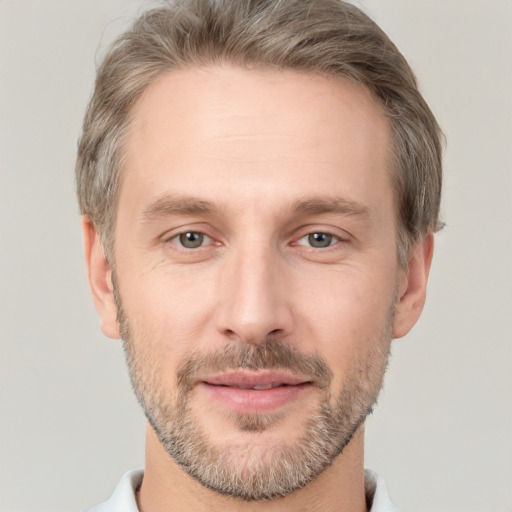 Joyful white adult male with short  brown hair and brown eyes