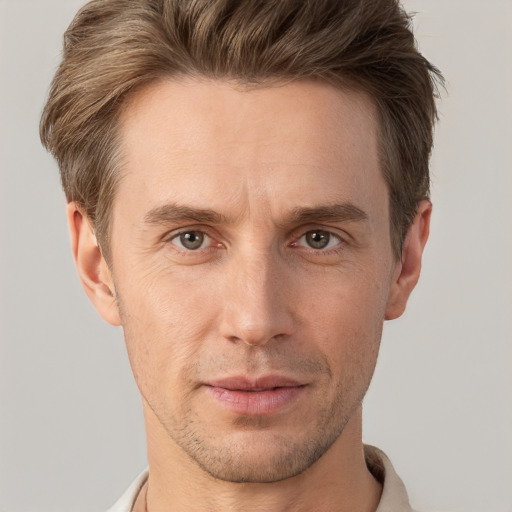 Joyful white adult male with short  brown hair and brown eyes