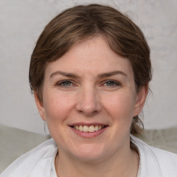 Joyful white adult female with medium  brown hair and grey eyes