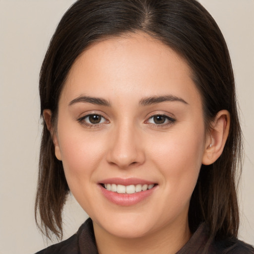 Joyful white young-adult female with long  brown hair and brown eyes