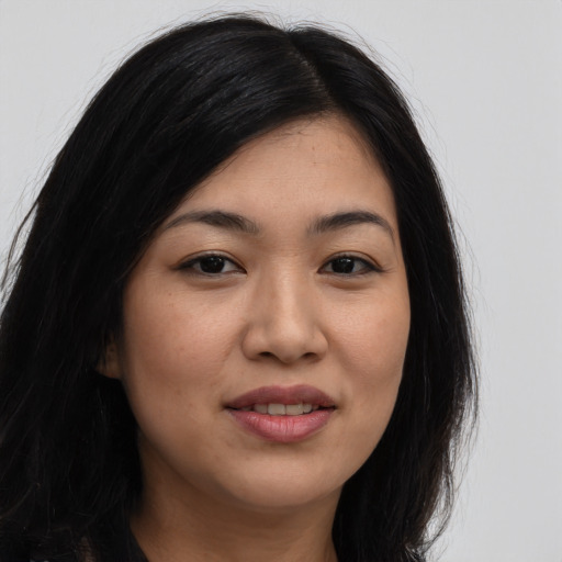 Joyful asian young-adult female with long  brown hair and brown eyes