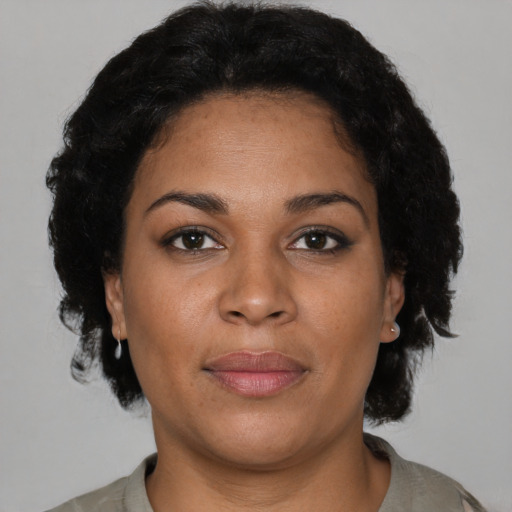Joyful latino adult female with short  brown hair and brown eyes