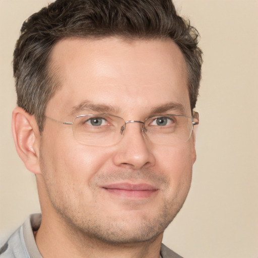 Joyful white adult male with short  brown hair and brown eyes