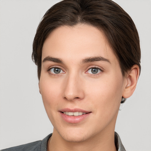 Joyful white young-adult female with short  brown hair and brown eyes