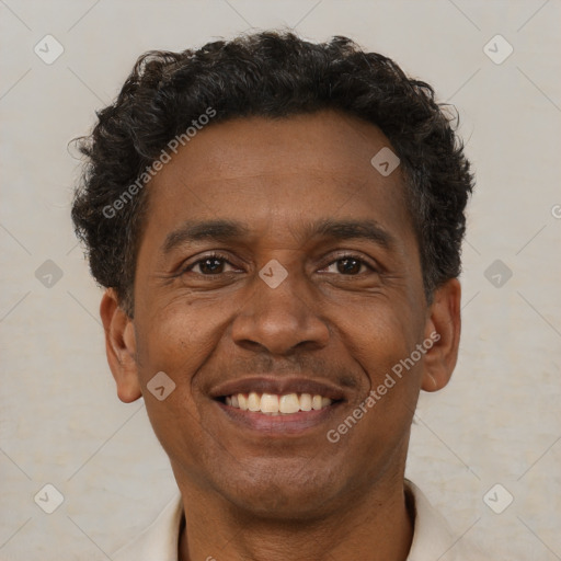 Joyful black adult male with short  brown hair and brown eyes