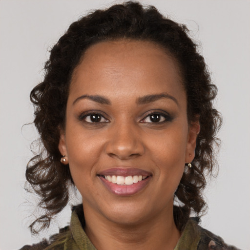 Joyful black young-adult female with medium  brown hair and brown eyes
