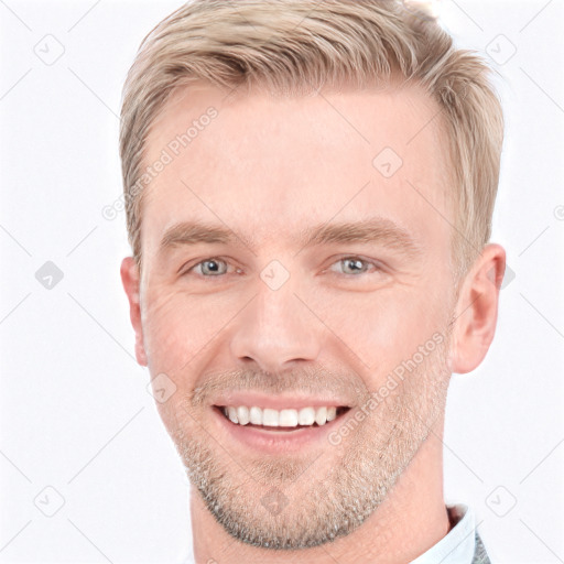 Joyful white young-adult male with short  brown hair and grey eyes