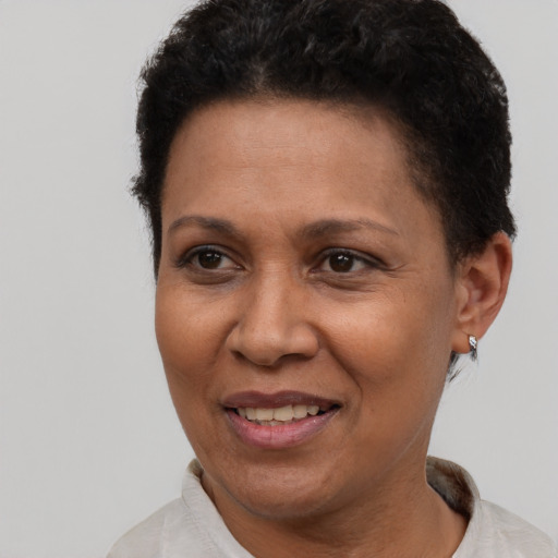 Joyful latino adult female with short  brown hair and brown eyes