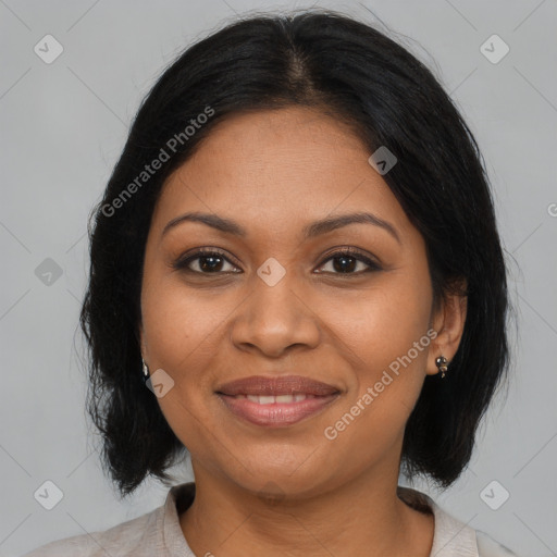 Joyful black adult female with medium  brown hair and brown eyes