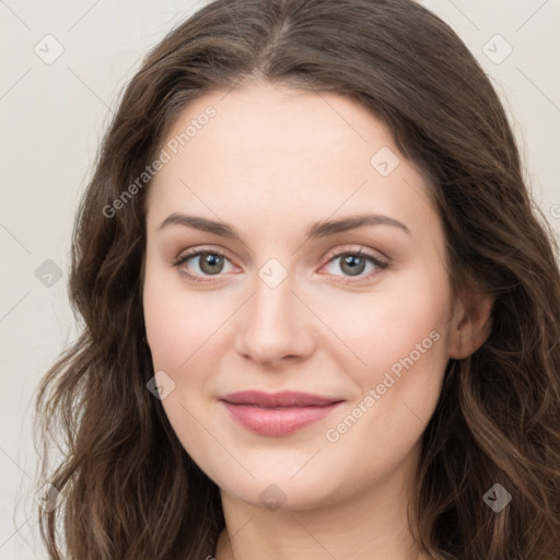 Joyful white young-adult female with long  brown hair and green eyes