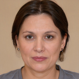 Joyful white adult female with medium  brown hair and brown eyes