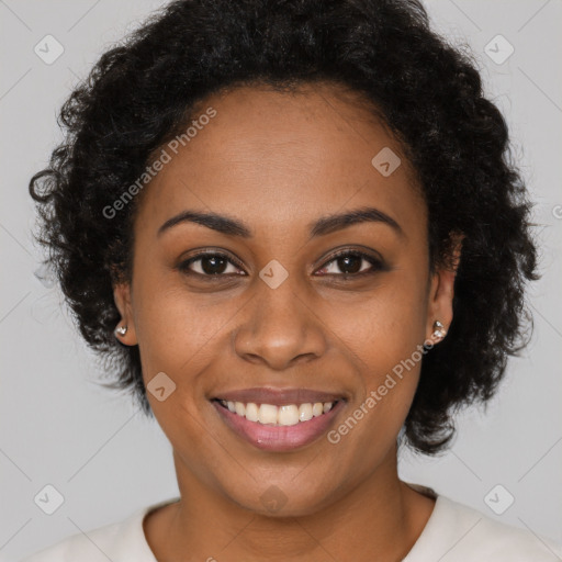 Joyful black young-adult female with long  brown hair and brown eyes