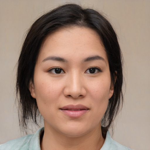 Joyful asian young-adult female with medium  brown hair and brown eyes