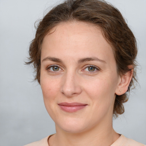 Joyful white young-adult female with medium  brown hair and green eyes