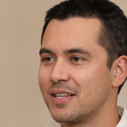 Joyful white young-adult male with short  black hair and brown eyes