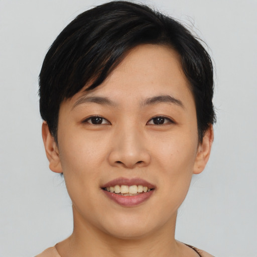 Joyful asian young-adult female with short  brown hair and brown eyes