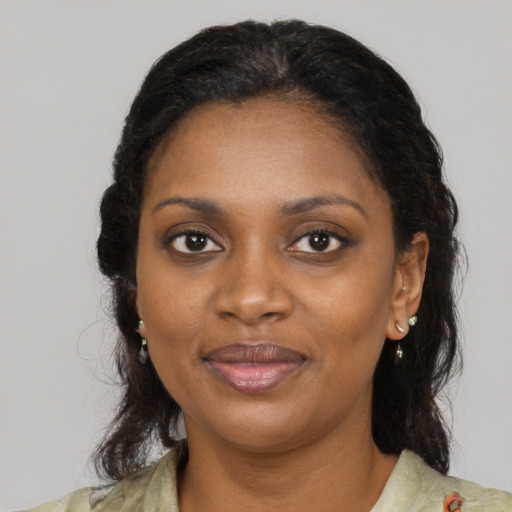 Joyful black young-adult female with medium  brown hair and brown eyes