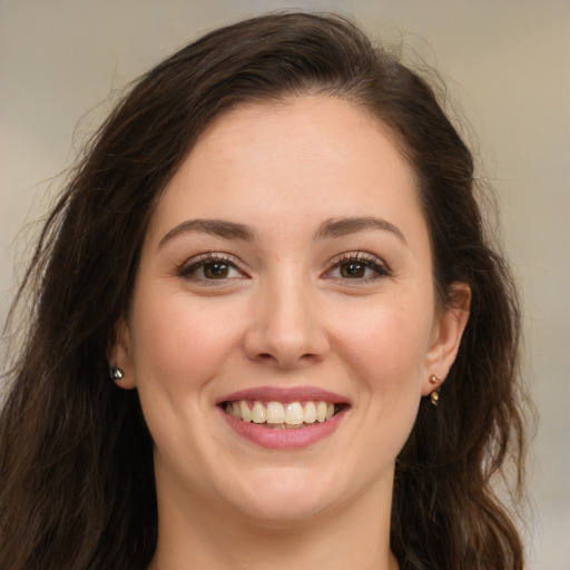 Joyful white young-adult female with long  brown hair and brown eyes