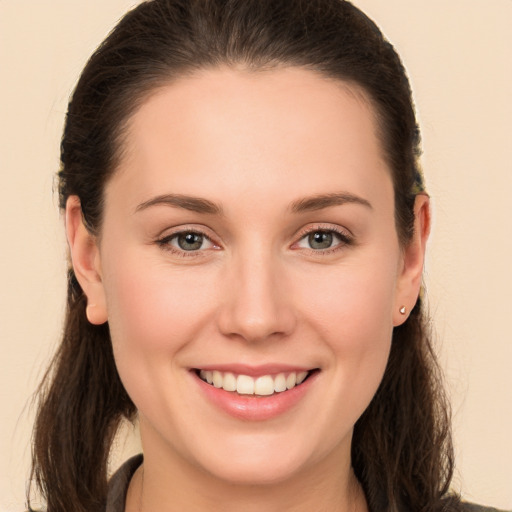 Joyful white young-adult female with long  brown hair and brown eyes