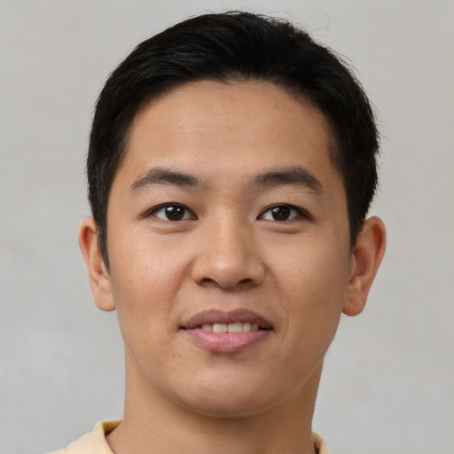 Joyful asian young-adult male with short  brown hair and brown eyes