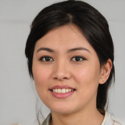 Joyful asian young-adult female with medium  brown hair and brown eyes