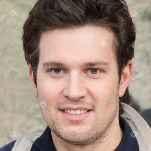 Joyful white adult male with short  brown hair and grey eyes