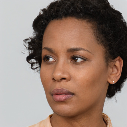 Neutral black young-adult female with short  brown hair and brown eyes
