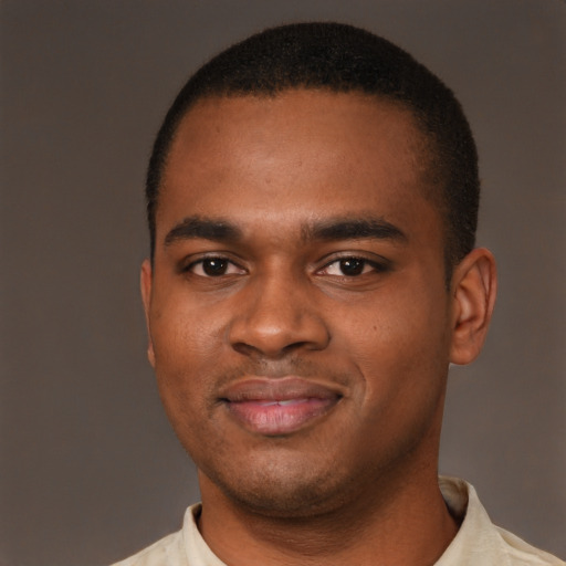 Joyful latino young-adult male with short  brown hair and brown eyes