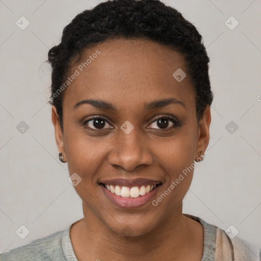 Joyful black young-adult female with short  black hair and brown eyes