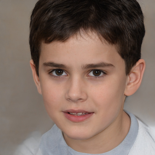 Joyful white child male with short  brown hair and brown eyes