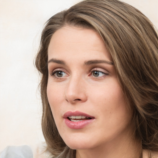 Joyful white young-adult female with medium  brown hair and green eyes