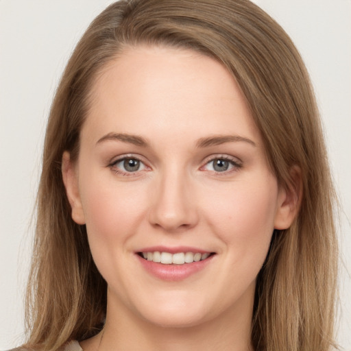 Joyful white young-adult female with long  brown hair and grey eyes